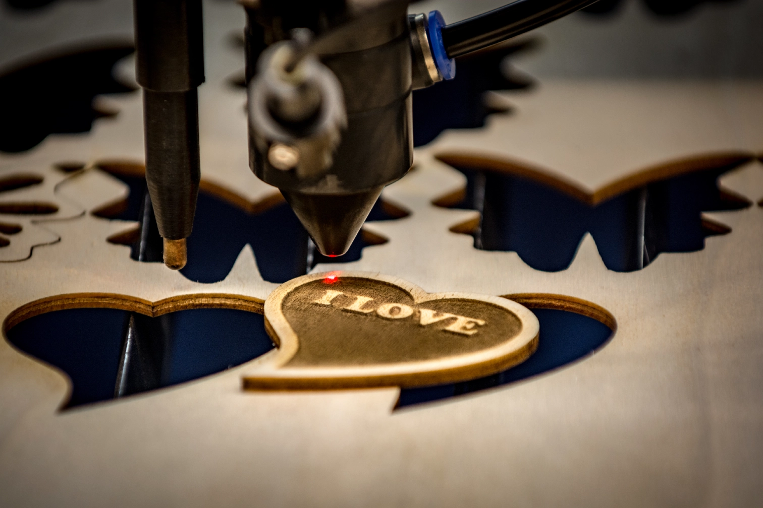 Laser engraving heart with "LOVE" text.