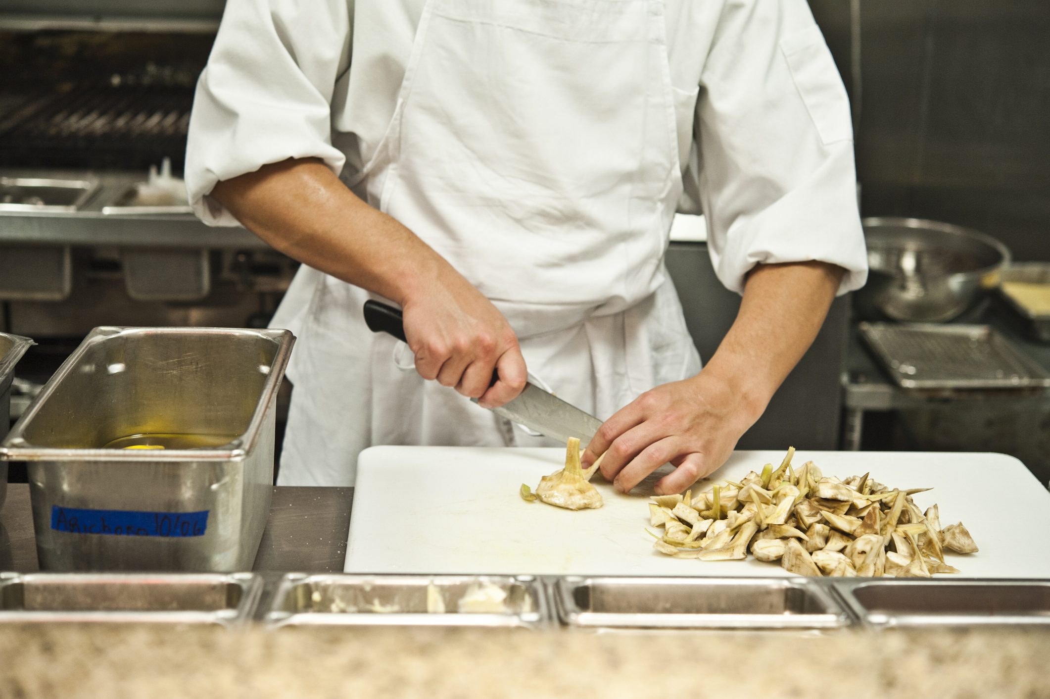 Chef chopping artichokes