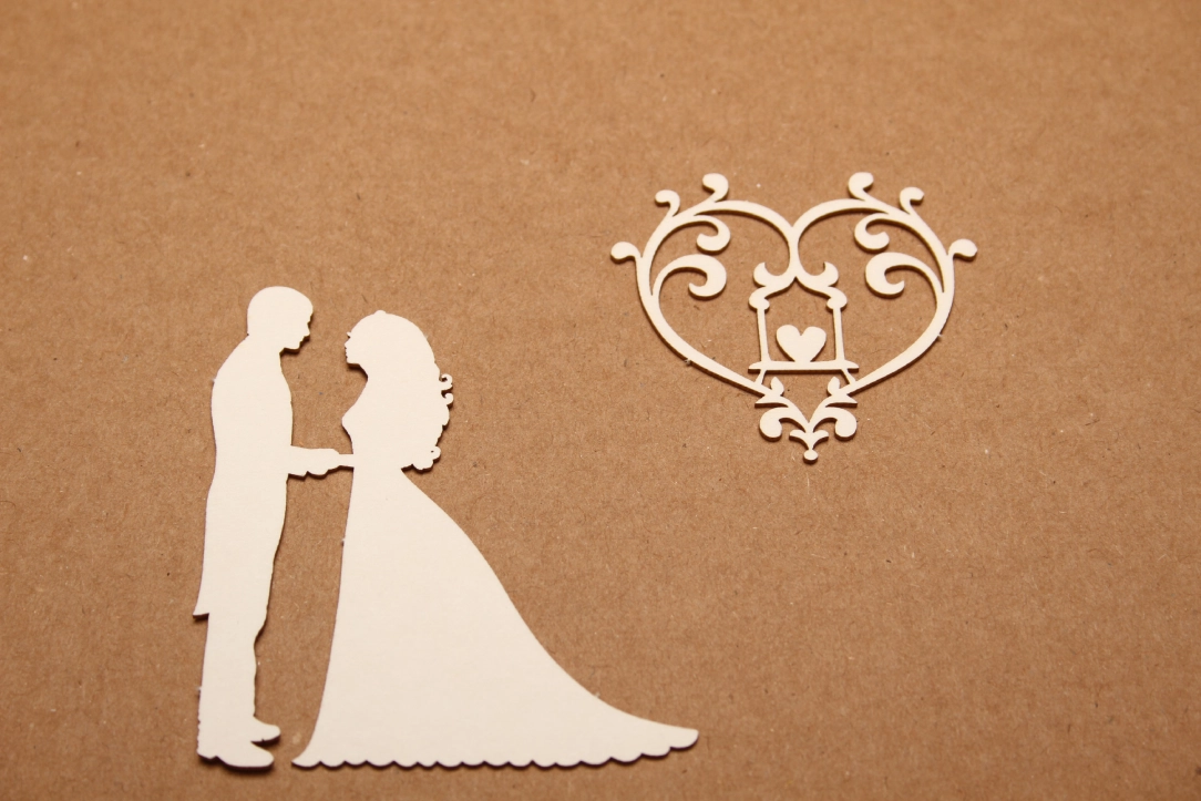 Silhouette of bride and groom with heart.